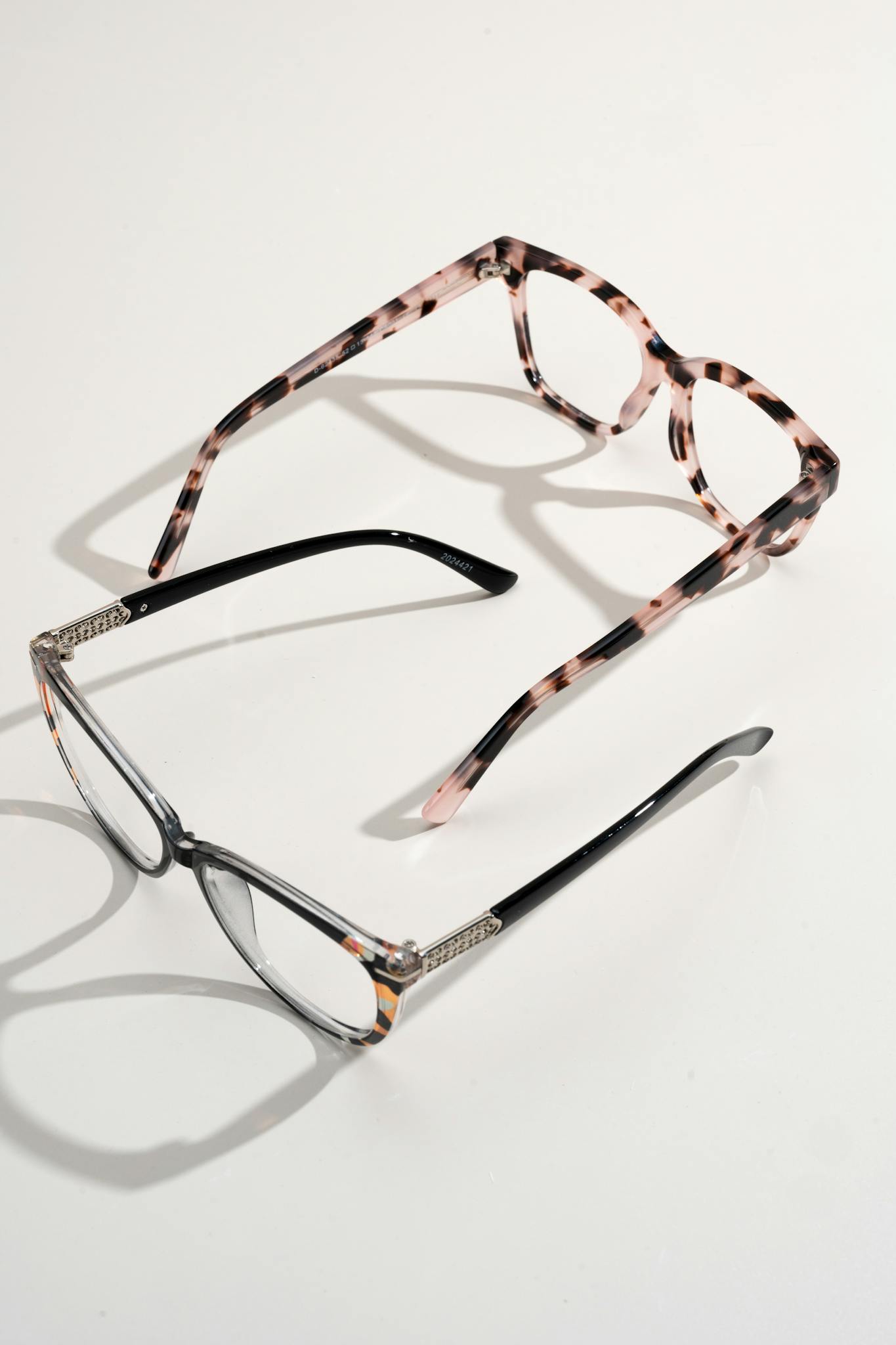 A pair of stylish eyeglasses and sunglasses displayed on a white background.